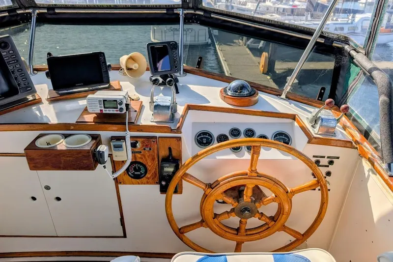 Slide: The Image of Helm of 1979 Grand Banks 42 Classic yacht with wooden wheel and navigation instruments. - 13
