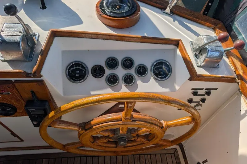 Slide: The Image of 1979 Grand Banks 42 Classic helm with wooden wheel and control panel. - 14