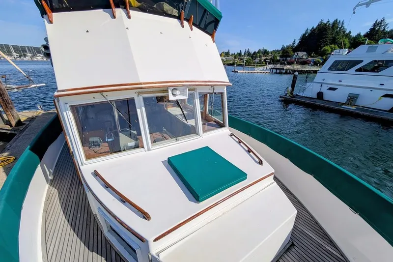 Slide: The Image of 1979 Grand Banks 42 Classic yacht docked at a marina, showcasing its deck and cabin. - 18