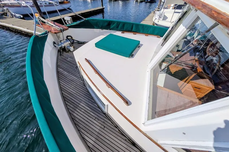 Slide: The Image of 1979 Grand Banks 42 Classic yacht deck with wooden accents and marina view. - 20