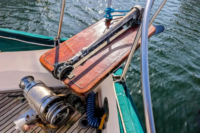 Slide: The Image of Deck of 1979 Grand Banks 42 Classic yacht with anchor winch and wooden platform. - 26