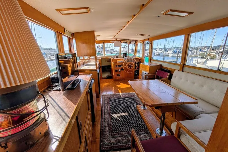 Slide: The Image of Interior of a 1979 Grand Banks 42 Classic yacht with wooden furnishings and marina view. - 28