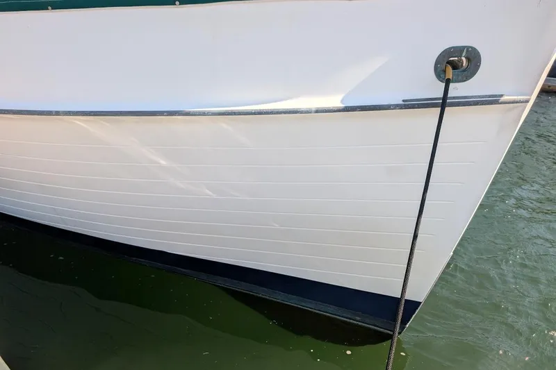 Slide: The Image of 1979 Grand Banks 42 Classic boat hull with mooring line in water. - 3