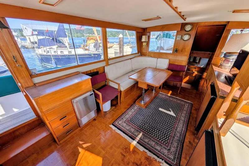 Slide: The Image of Interior of a 1979 Grand Banks 42 Classic yacht with wood furnishings and waterfront view. - 30