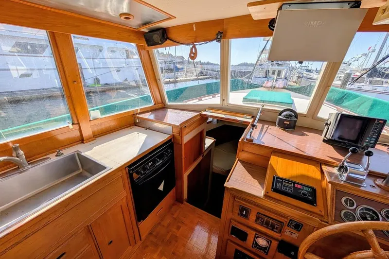 Slide: The Image of 1979 Grand Banks 42 Classic yacht interior with helm, kitchen, and navigation equipment. - 31
