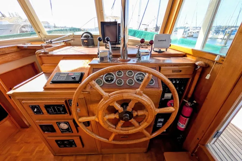 Slide: The Image of Helm of 1979 Grand Banks 42 Classic yacht with wooden wheel and navigation instruments. - 33