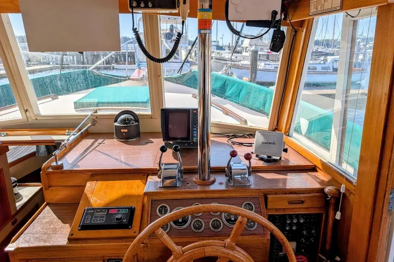 Slide: The Image of 1979 Grand Banks 42 Classic helm with navigation equipment and wooden steering wheel. - 34
