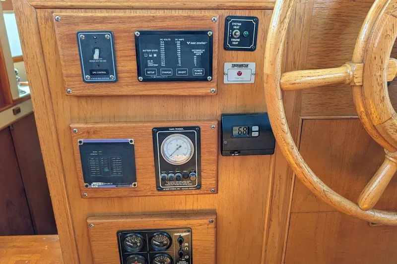 Slide: The Image of Control panel of a 1979 Grand Banks 42 Classic boat with wooden steering wheel. - 36