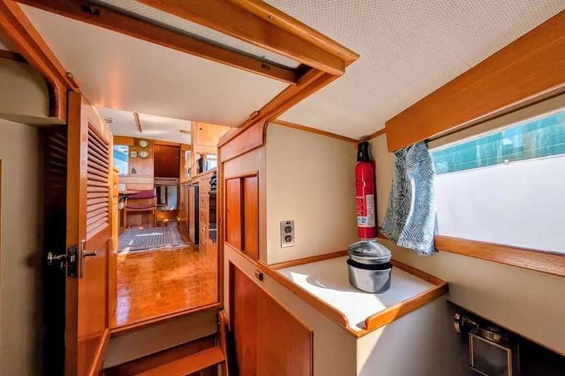 Slide: The Image of Interior of 1979 Grand Banks 42 Classic yacht with wooden finishes and nautical decor. - 44