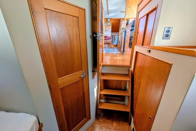 Slide: The Image of Interior of 1979 Grand Banks 42 Classic yacht, featuring wooden stairs and cabinetry. - 46