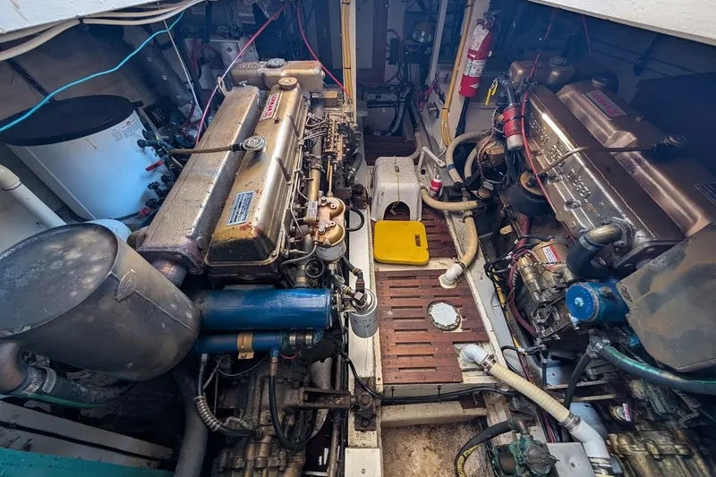 Slide: The Image of Engine room of a 1979 Grand Banks 42 Classic yacht, showcasing dual engines and equipment. - 49