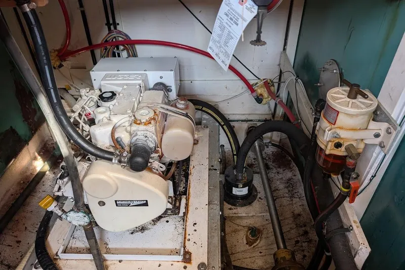 Slide: The Image of Engine room of a 1979 Grand Banks 42 Classic boat, showcasing mechanical components and wiring. - 52