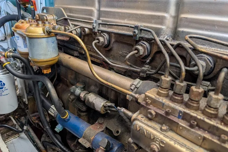 Slide: The Image of Engine components of a 1979 Grand Banks 42 Classic boat, showcasing intricate mechanical details. - 53