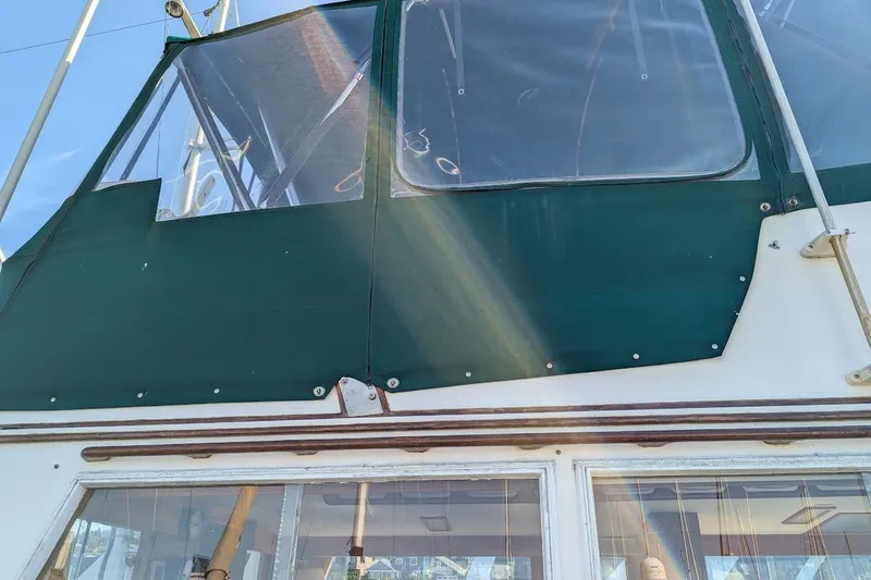 Slide: The Image of 1979 Grand Banks 42 Classic boat with green canvas cover and clear windows. - 8