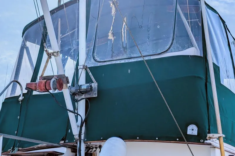 Slide: The Image of 1979 Grand Banks 42 Classic boat with green canvas enclosure and winch system. - 9