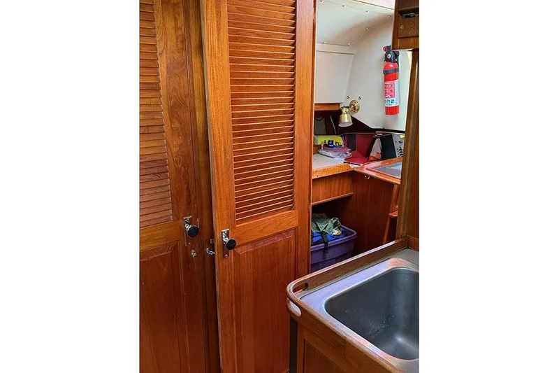 Slide: The Image of Interior of 1982 C&C Landfall 38 sailboat with wooden cabinetry and sink. - 10