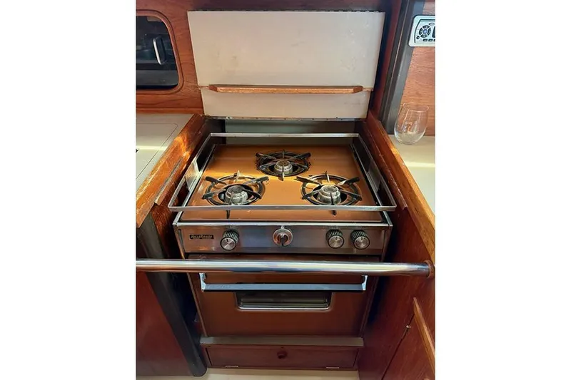 Slide: The Image of 1982 C&C Landfall 38 yacht kitchen with a two-burner stove and oven. - 13