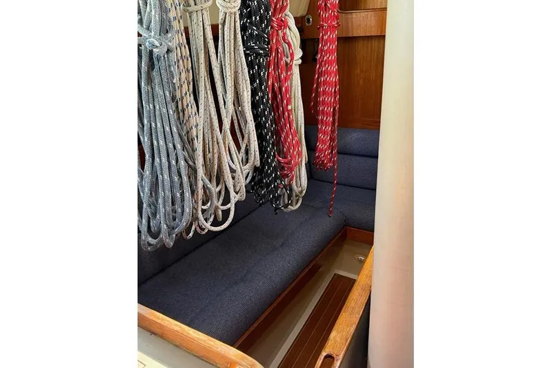 Slide: The Image of Interior of 1982 C&C Landfall 38 sailboat with ropes and blue seating. - 15