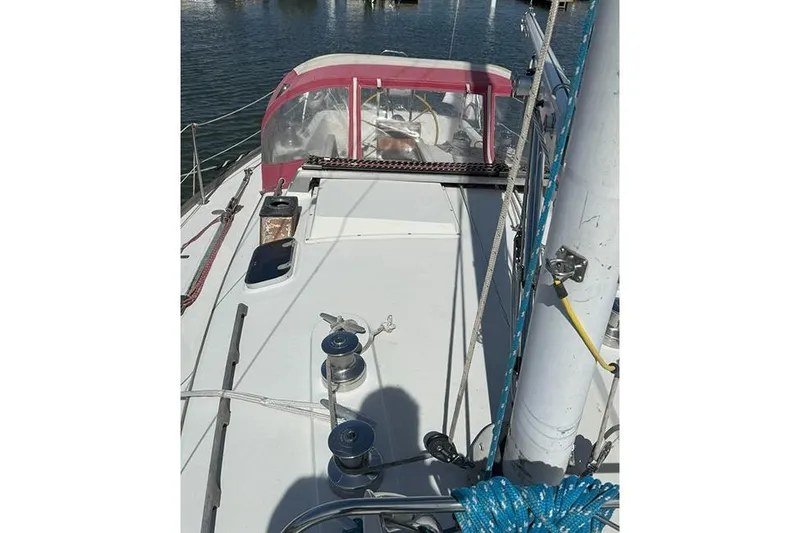 Slide: The Image of 1982 C&C Landfall 38 sailboat deck with winches and ropes, docked in calm waters. - 3