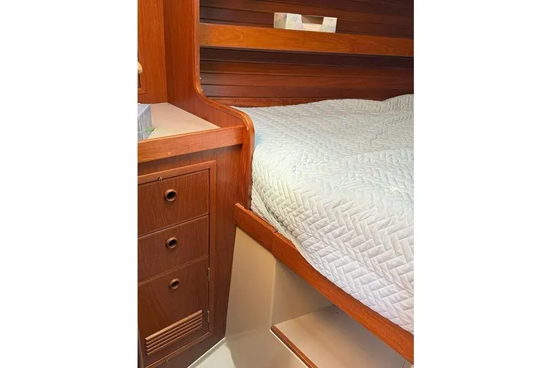 Slide: The Image of Interior cabin of 1982 C&C Landfall 38 sailboat with wooden cabinetry and bed. - 5