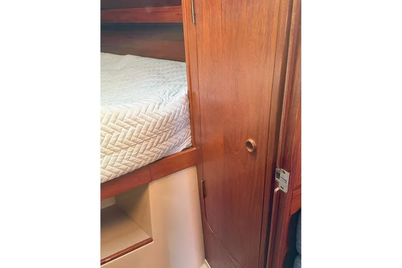 Slide: The Image of Interior of 1982 C&C Landfall 38 sailboat with wooden door and cozy bed. - 7