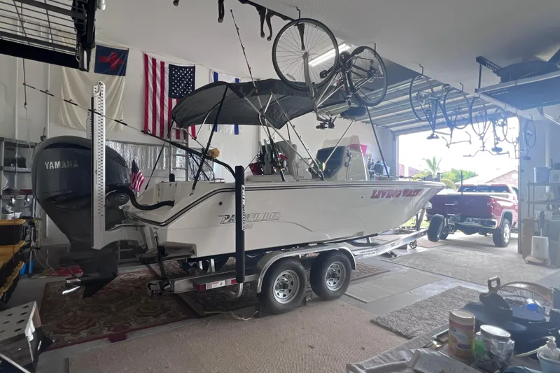 Slide: The Image of 2024 Pathfinder 2400 Open boat on trailer in garage with bicycles overhead. - 2