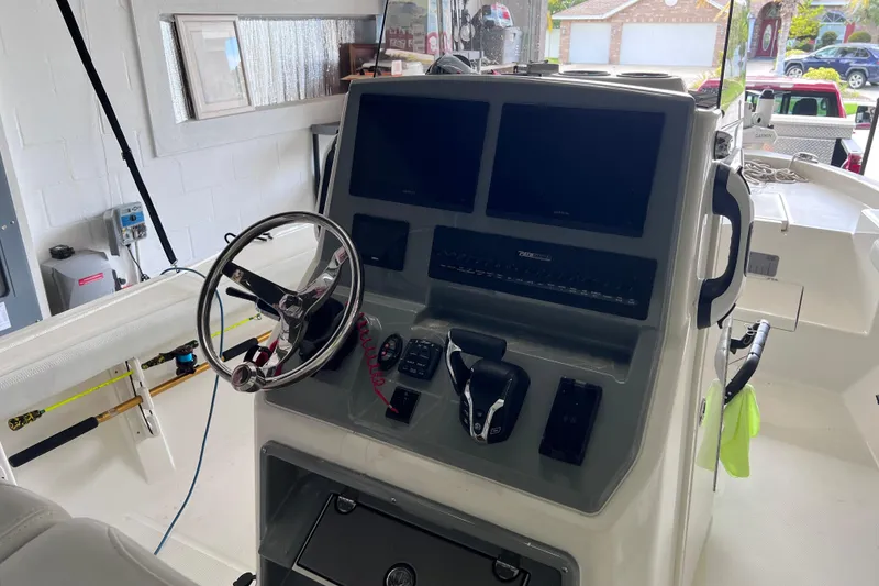 Slide: The Image of 2024 Pathfinder 2400 Open boat dashboard with steering wheel and electronic controls. - 4