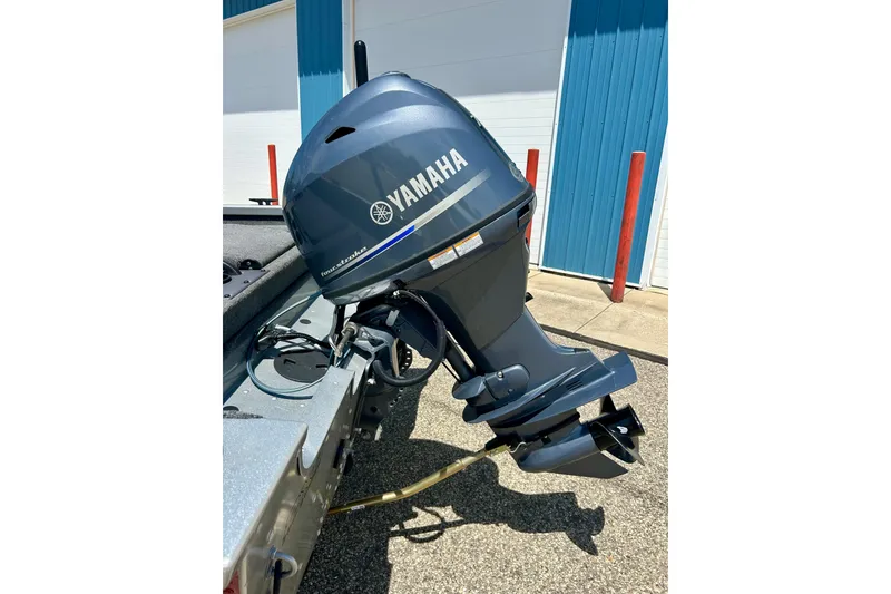 Slide: The Image of 2019 Alumacraft Classic 165 Sport with Yamaha outboard motor in a sunny outdoor setting. - 13