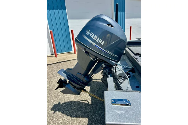 Slide: The Image of 2019 Alumacraft Classic 165 Sport with Yamaha outboard motor in a sunny outdoor setting. - 14