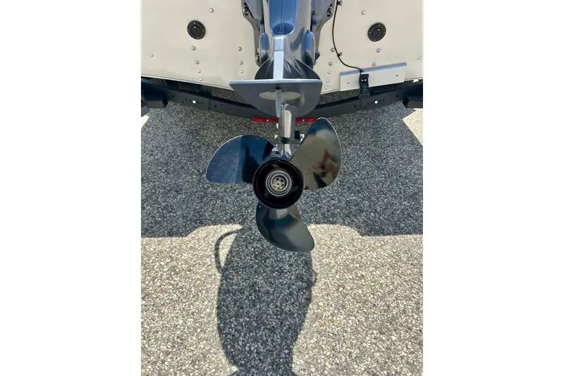 Slide: The Image of Propeller of 2019 Alumacraft Classic 165 Sport boat on pavement background. - 16