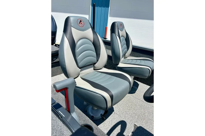Slide: The Image of 2019 Alumacraft Classic 165 Sport boat seats, gray and black design, outdoor setting. - 17