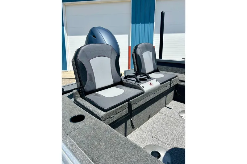 Slide: The Image of 2019 Alumacraft Classic 165 Sport boat seats, gray and black, in a sunny outdoor setting. - 22