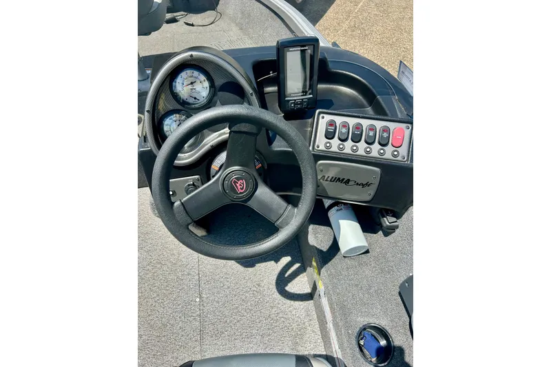 Slide: The Image of 2019 Alumacraft Classic 165 Sport dashboard with steering wheel and control panel. - 27