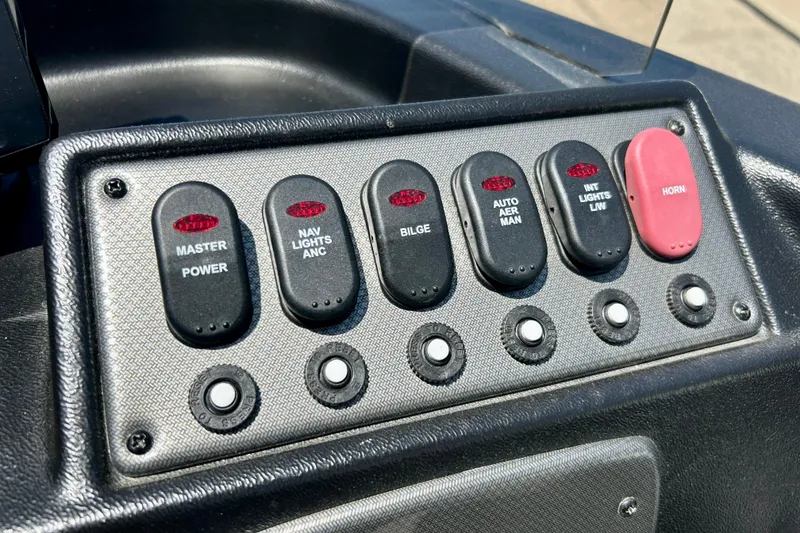 Slide: The Image of Control panel of a 2019 Alumacraft Classic 165 Sport boat with labeled switches. - 28