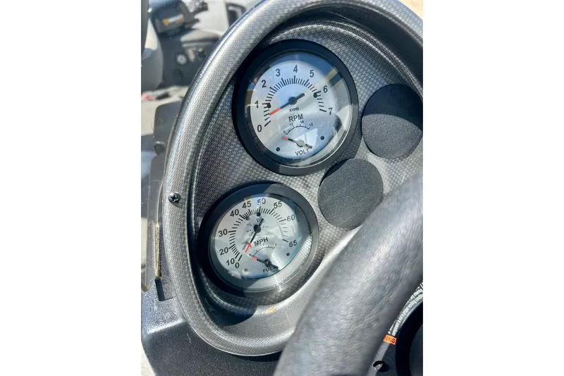 Slide: The Image of Dashboard gauges of a 2019 Alumacraft Classic 165 Sport boat. - 29