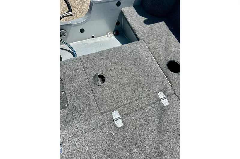 Slide: The Image of 2019 Alumacraft Classic 165 Sport boat interior with carpeted flooring and storage compartments. - 37