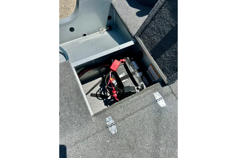 Slide: The Image of 2019 Alumacraft Classic 165 Sport boat battery compartment with wiring and carpeted interior. - 38