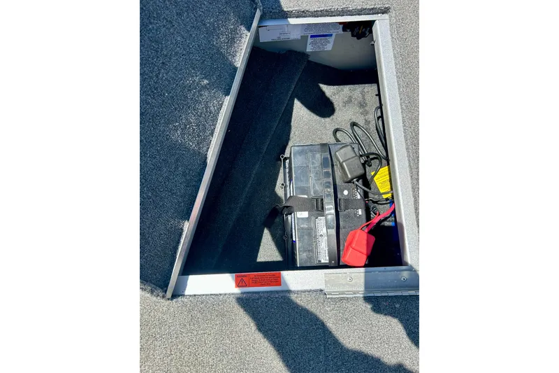 Slide: The Image of 2019 Alumacraft Classic 165 Sport boat battery compartment with cables and secure straps. - 44
