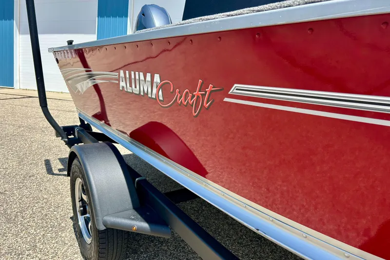 Slide: The Image of 2019 Alumacraft Classic 165 Sport boat, red exterior, parked on trailer. - 5