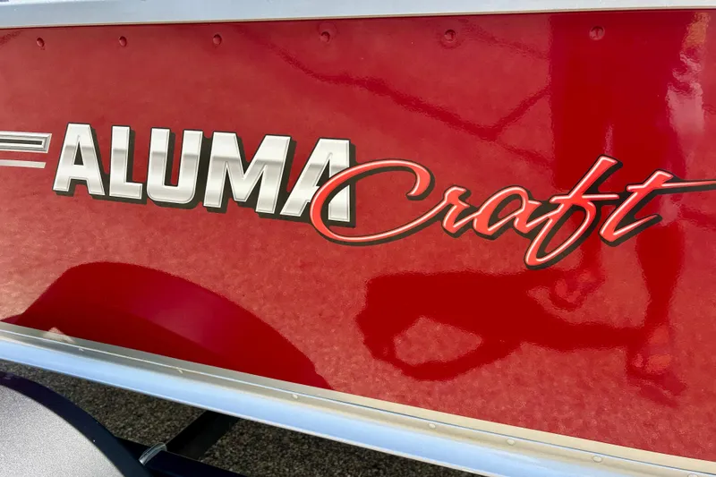Slide: The Image of Red 2019 Alumacraft Classic 165 Sport boat with bold logo on the side. - 7