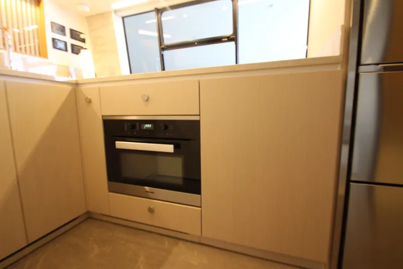 Slide: The Image of Modern kitchen interior on Azimut Fly 68 yacht, featuring sleek cabinetry and built-in oven. - 23