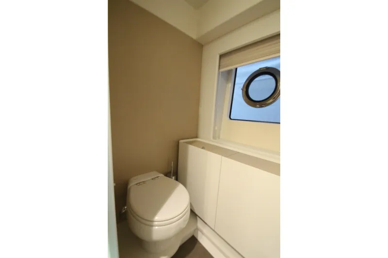 Slide: The Image of Modern bathroom interior on 2023 Azimut Fly 68 yacht, featuring sleek design and porthole window. - 76