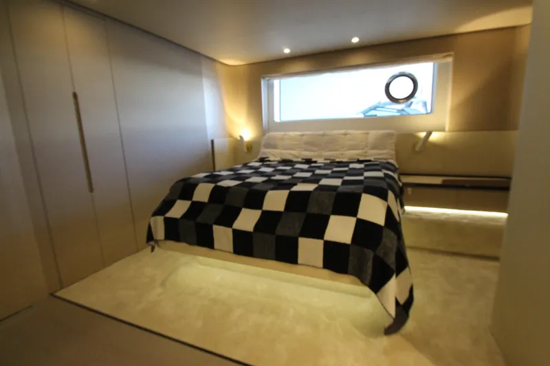 Slide: The Image of Luxurious bedroom interior of 2023 Azimut Fly 68 yacht with checkered bedding. - 64