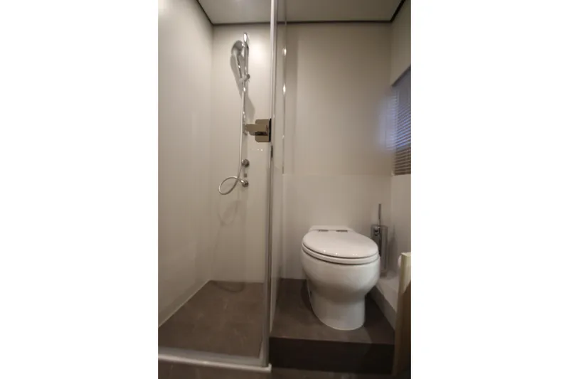 Slide: The Image of Bathroom interior of 2023 Azimut Fly 68 yacht, featuring shower and toilet. - 48