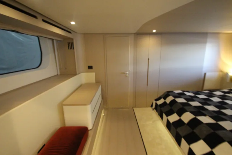 Slide: The Image of Luxurious interior of 2023 Azimut Fly 68 yacht with modern design and checkered bedding. - 77