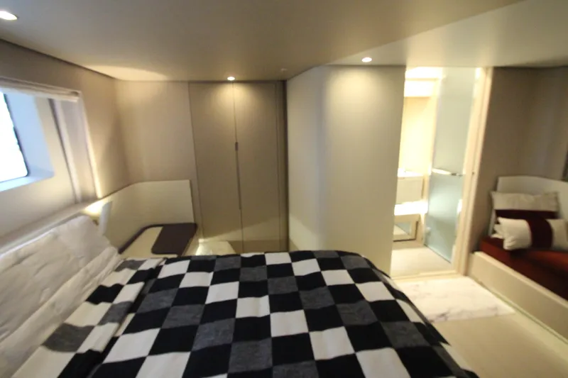 Slide: The Image of Luxurious bedroom interior of 2023 Azimut Fly 68 yacht with modern design and checkered bedding. - 69