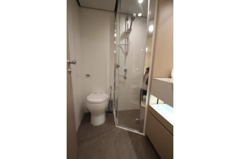Slide: The Image of Bathroom interior of 2023 Azimut Fly 68 yacht, featuring modern shower and toilet. - 55