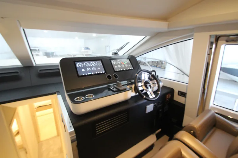 Slide: The Image of Interior helm of 2023 Azimut Fly 68 yacht with modern controls and steering wheel. - 29