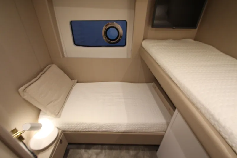 Slide: The Image of 2023 Azimut Fly 68 yacht cabin with twin beds and modern decor. - 37
