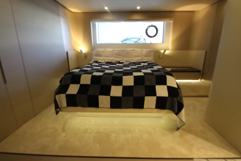 Slide: The Image of Luxurious bedroom interior of 2023 Azimut Fly 68 yacht with checkered bedspread. - 65
